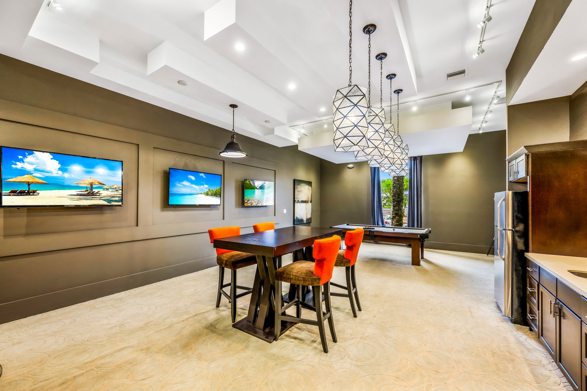 A modern dining room with a wooden table and chairs.
